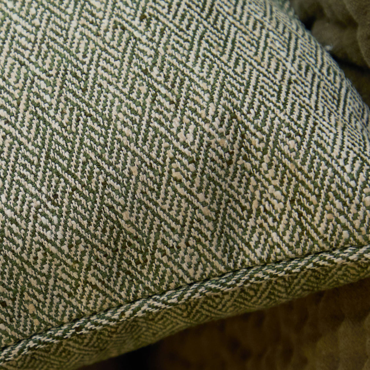 Close-up of green and beige herringbone patterned fabric