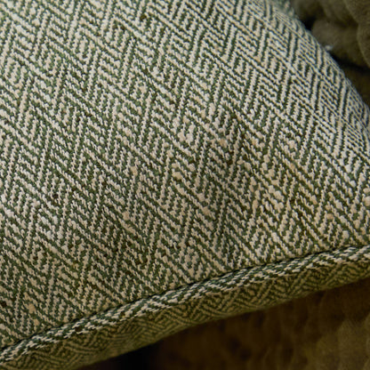 Close-up of green and beige herringbone patterned fabric