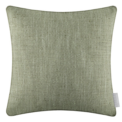 Green textured pillow with a tag on a white background