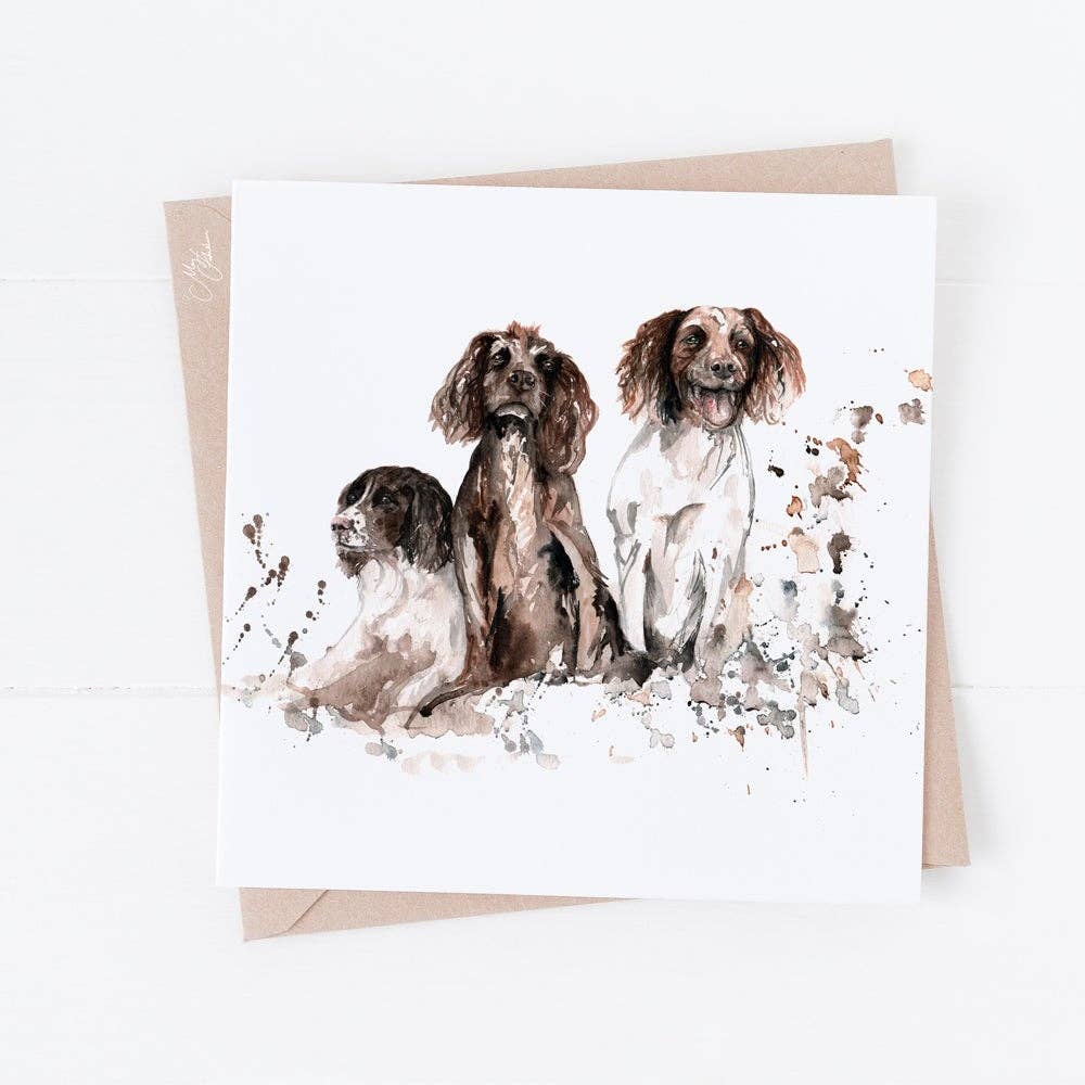Greeting card with watercolor illustration of three dogs on a white background