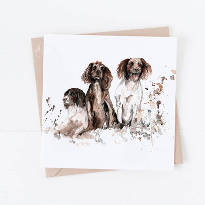 Greeting card with watercolor illustration of three dogs on a white background