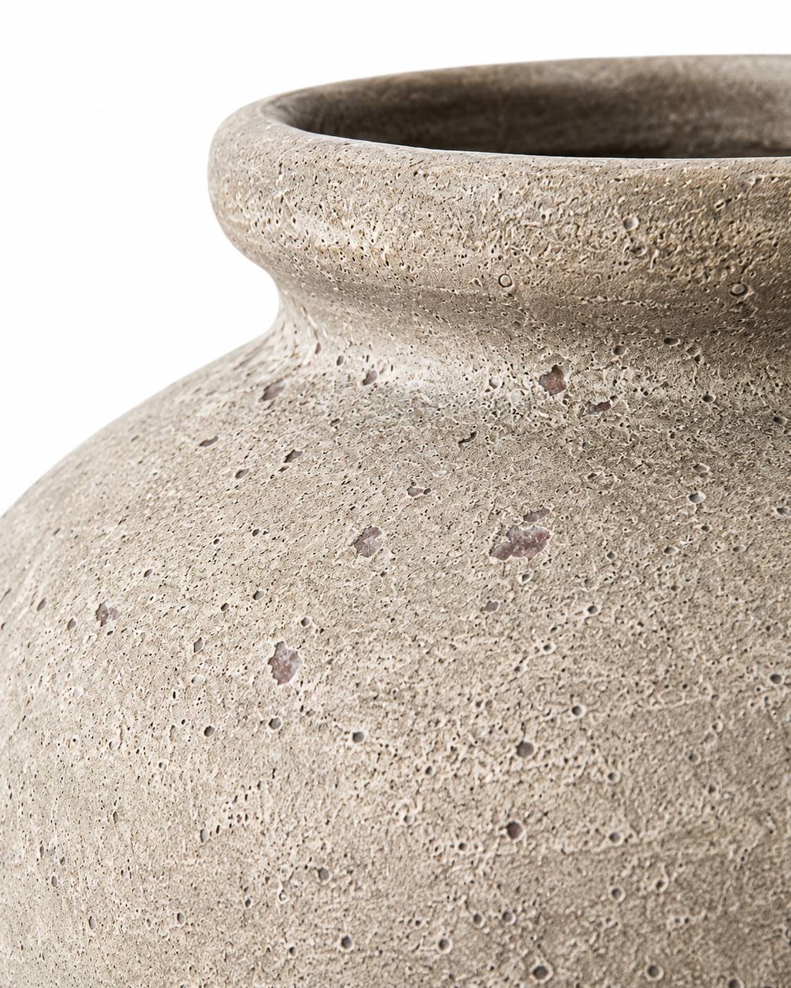 Close-up of a textured ceramic vase in a warm grey-beige stoneware finish, showing the porous surface and flared rim against a white background.